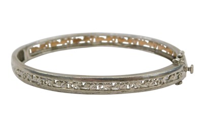 Lot 447A - A half hinged bangle, with central scroll...