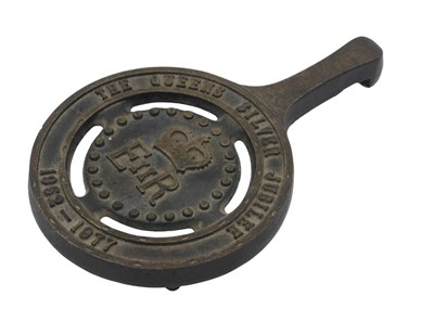 Lot 675 - A Queen's silver jubilee cast iron trivet...