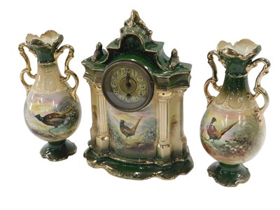 Lot 695 - A 20thC ceramic clock garniture set, the...