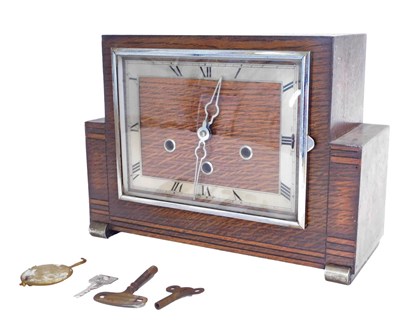 Lot 711 - A 1950s Art Deco style oak cased mantel clock,...