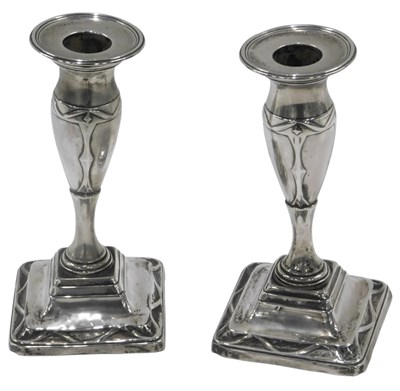 Lot 253 - A pair of Edwardian silver candlesticks, with...