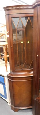 Lot 1536 - A breakfront corner cabinet, glazed door, with...