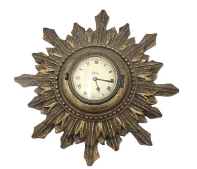 Lot 303A - A small sunburst timepiece, the gold coloured...