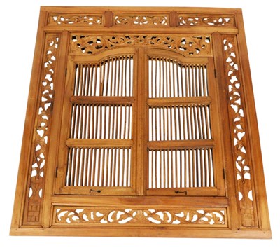 Lot 314 - An Indonesian carved wooden mirror, of window...