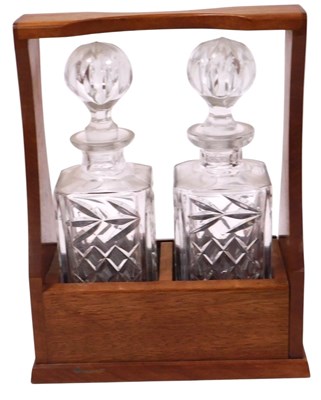 Lot 80 - A teak cased two bottle tantalus, containing a...
