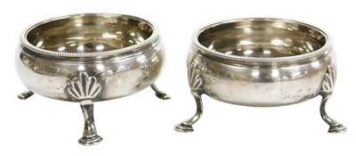 Lot 123 - A pair of George III silver circular salts,...