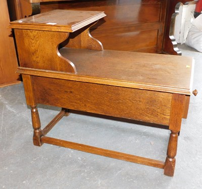 Lot 1063 - An oak telephone table, 63cm high, 75cm wide,...