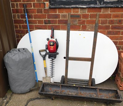 Lot 1090 - A white plastic oval topped garden table, the...