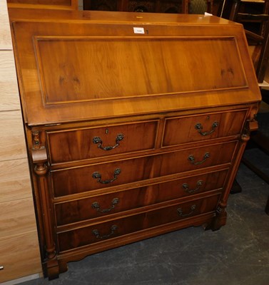 Lot 1048 - A 20thC yew bureau, the fall enclosing an...