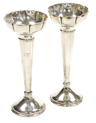 Lot 325 - A pair of George V loaded silver bud vases, of...