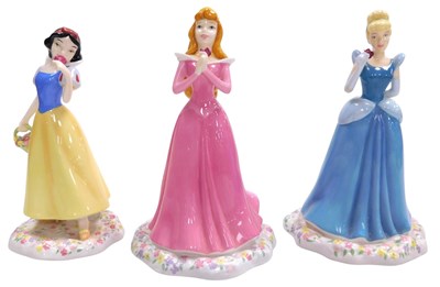 Lot 295 - Three Royal Doulton Disney Princesses...