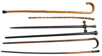Lot 402 - A group of walking canes and sticks, one...