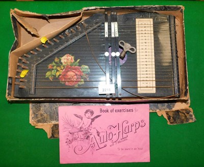 Lot 2218 - An autoharp in an ebonised case, with printed...
