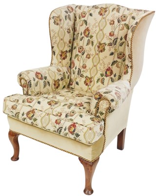 Lot 480 - A Georgian style wingback armchair, with...