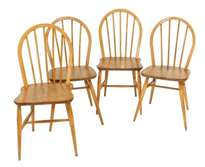 Lot 482 - A set of four Ercol light elm spindle back...
