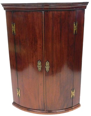 Lot 511 - A George III mahogany cylinder fronted hanging...