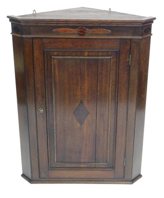 Lot 526 - A George III oak hanging corner cupboard, 96cm...