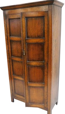 Lot 468 - A 1930s fitted oak hall robe, with panel front,...