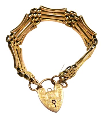 Lot 595 - A 9ct gold three bar gate bracelet, with a...