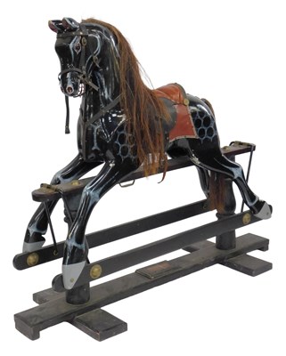 Lot 16 - A dapple black rocking horse, with horse hair...
