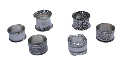 Lot 245 - Six silver napkin rings, each of differing...