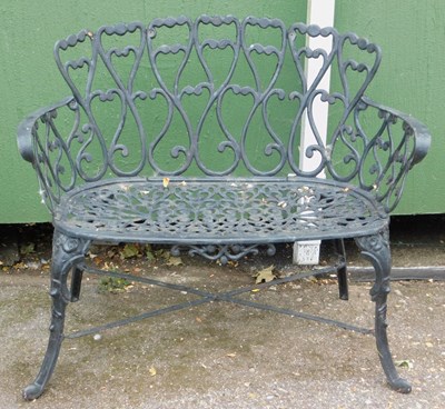 Lot 306 - A black painted cast iron two seater garden...