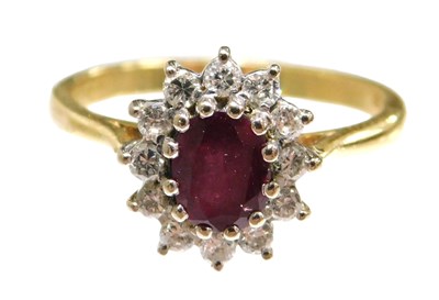 Lot 66 - An 18ct gold ruby and diamond ring, the oval...