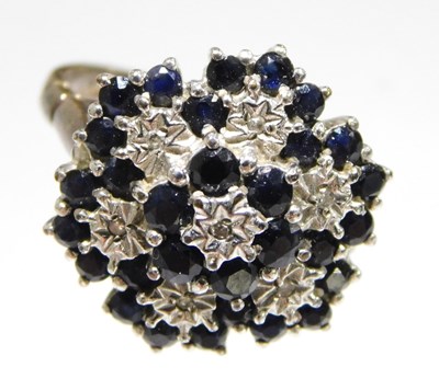 Lot 657 - A 9ct gold sapphire and diamond flowerhead...