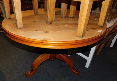 Lot 1021 - A light wood circular-topped dining table,...