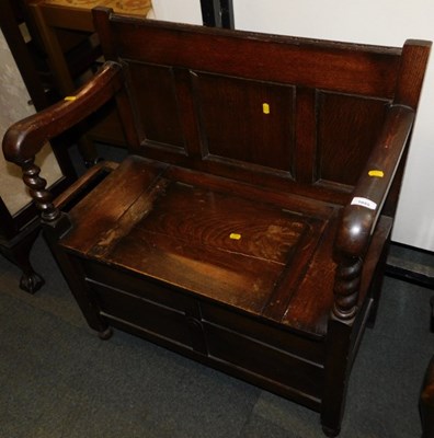 Lot 1055 - An oak hall chair, with lift-up seat, and an...