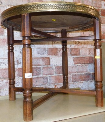 Lot 1057 - A circular folding table brass tray top table,...