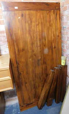 Lot 1070 - A modern dark wood dining table, raised on...