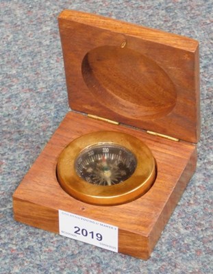 Lot 2019 - A wooden cased brass bound compass.