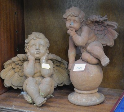 Lot 2023 - Two putti, one seated, one seated on a large...