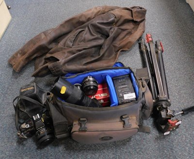 Lot 2049 - A leather jacket and Minolta camera equipment.