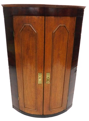 Lot 668 - A George III oak and mahogany bow front wall...