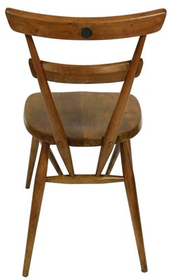Lot 669 - An Ercol blond elm and beech green dot dining...
