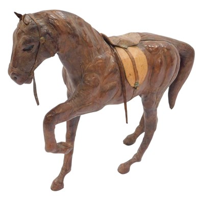Lot 439 - A 20thC leather model of a horse, with one leg...