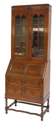 Lot 497 - An early 20thC oak bureau bookcase, the top...