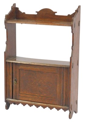 Lot 503 - An early 20thC oak hanging wall shelf, the...