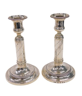 Lot 108 - A pair of Georgian silver candlesticks, with...