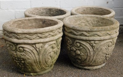 Lot 477 - Four composition stone garden planters, of...
