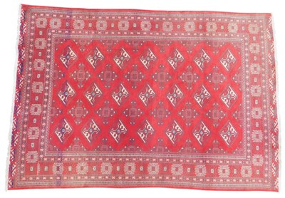 Lot 602 - A Turkamen rug, red ground decorated with five...