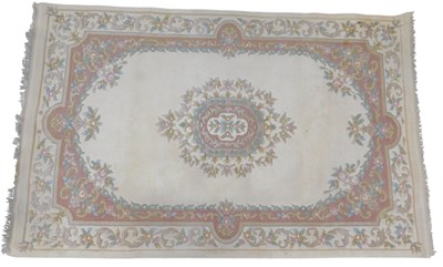 Lot 606 - An Aubusson style carpet, cream ground with...
