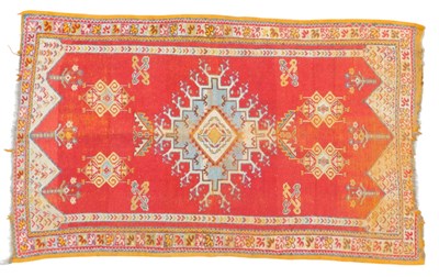 Lot 608 - A Turkish rug, red ground decorated with a...