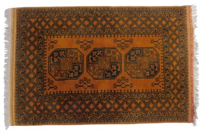 Lot 609 - An Afghan rug, mustard ground with three...
