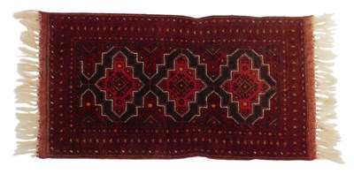 Lot 610 - A Turkamen rug, red ground with three central...