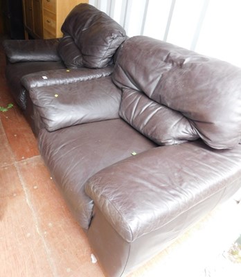 Lot 1099 - A pair of brown leather armchairs, 109cm wide.