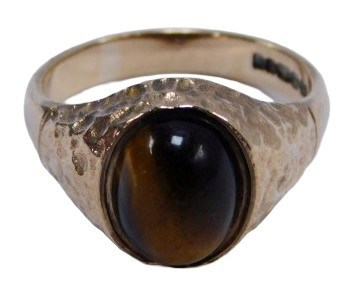 Lot 133 - A 9ct gold tigers eye dress ring, the oval...