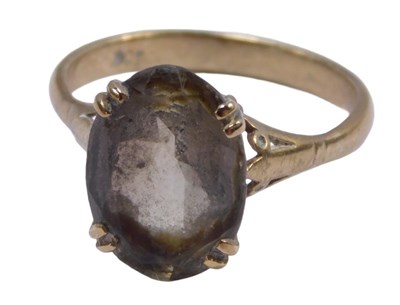Lot 565 - A smokey quartz dress ring, set with an oval...